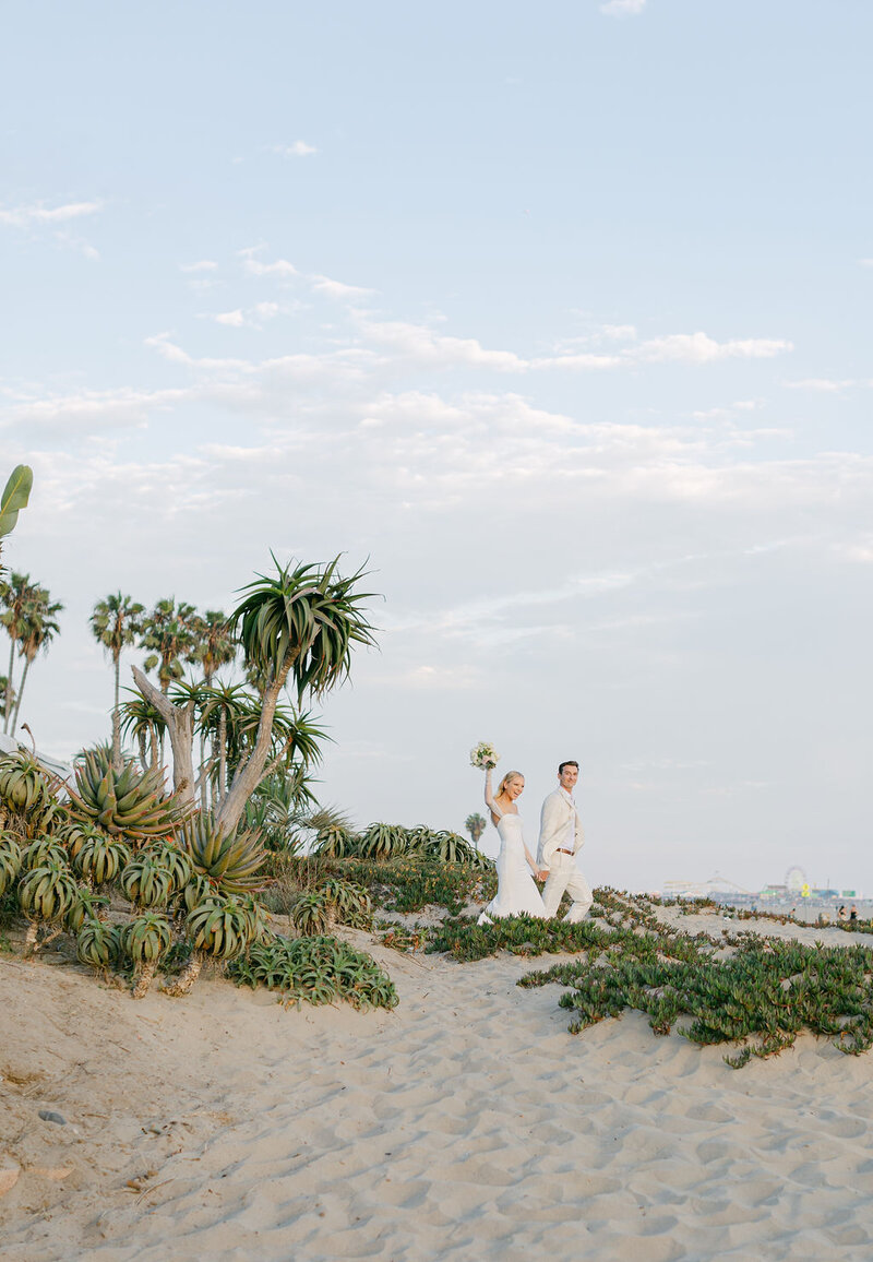 jonathan Beach CLub bride and groom entering reception happily on sand