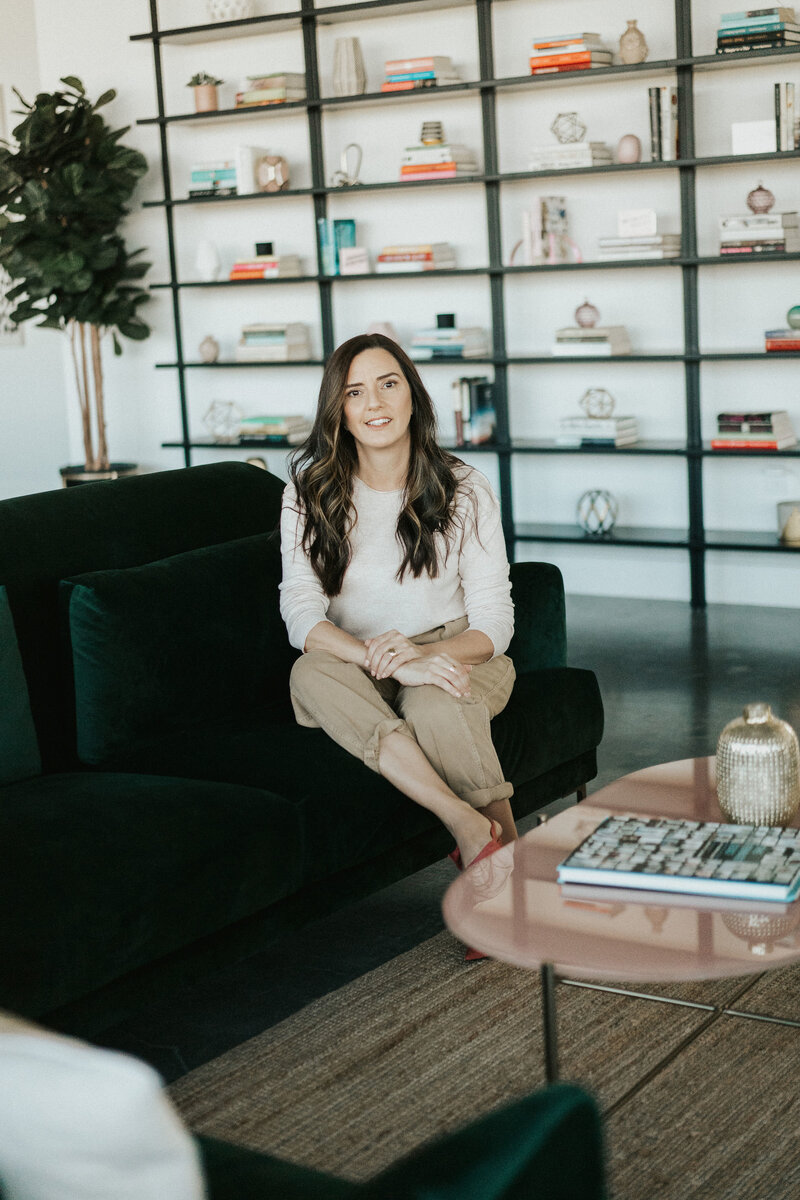 Idit sits in her therapy office as she smiles for the camera. Contact a couples therapist in Florida. Contact a Florida therapist for support today!