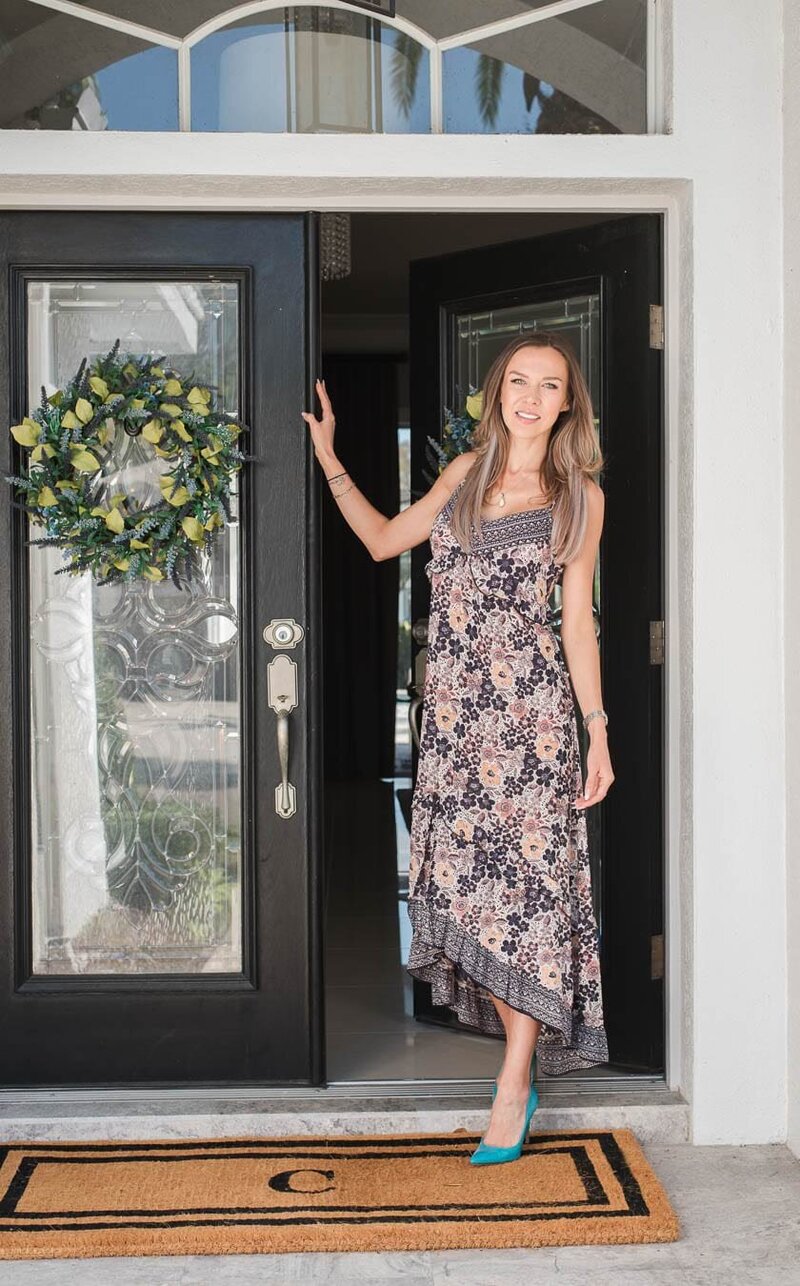 Tampa realtor personal brand showing a woman standing in front of an upscale front door with a wreath.