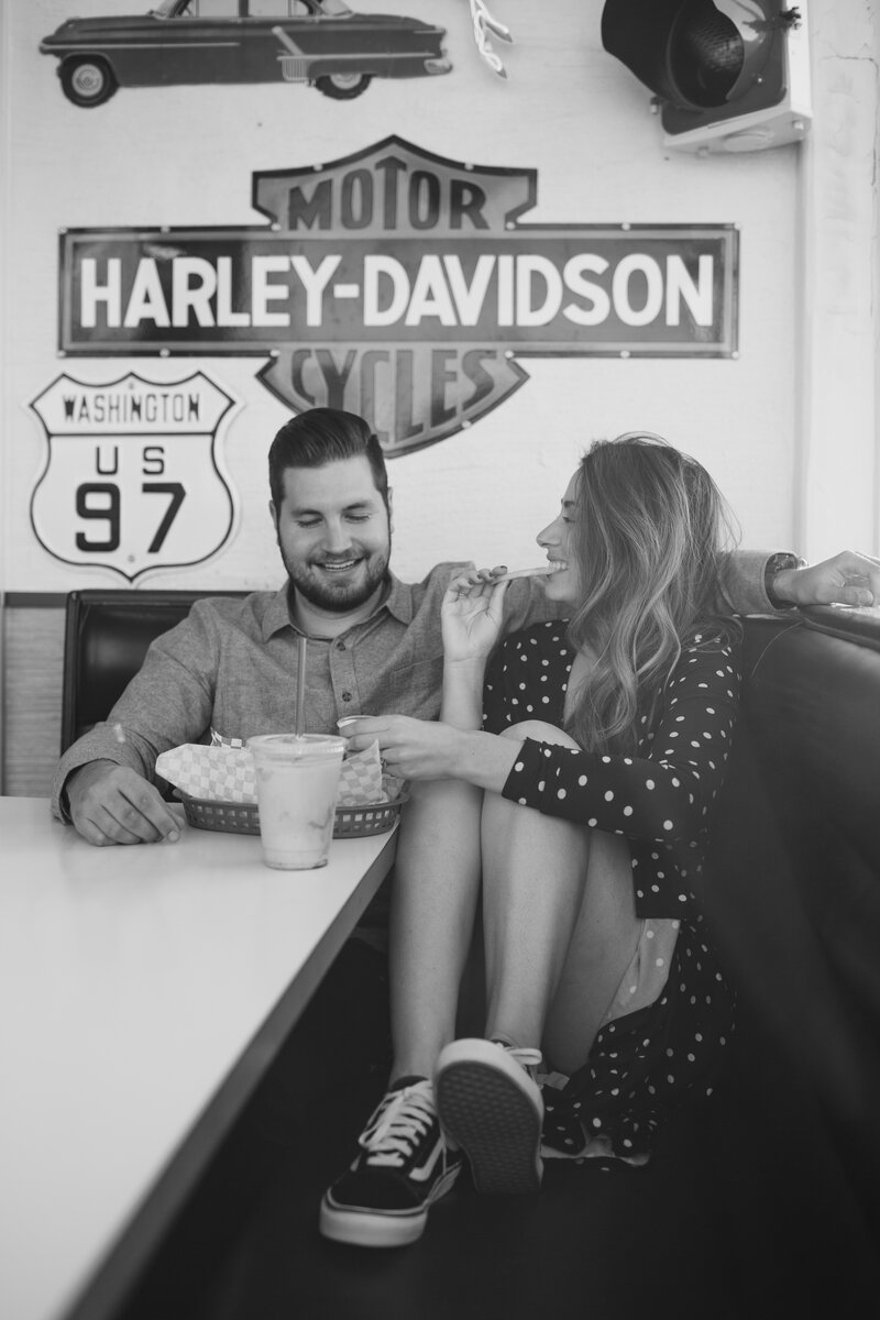 Couple sitting in booth at retro diner