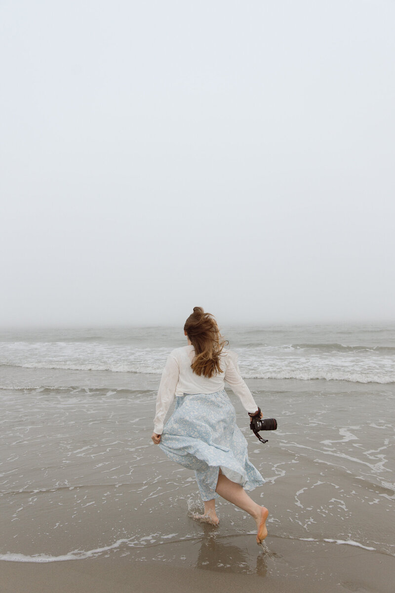 Cloudy day with a photographer running on the beach in Charleston, South Carolina