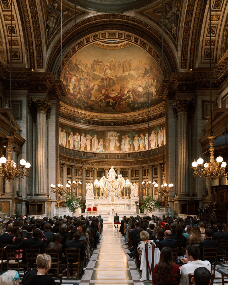 bride and groom at the end of the aisle in a church in paris