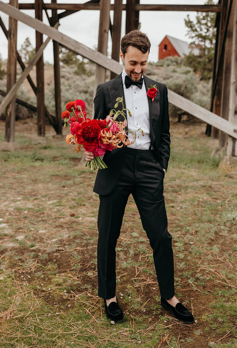 Spring wedding bouquet with protea, lilies, and garden roses