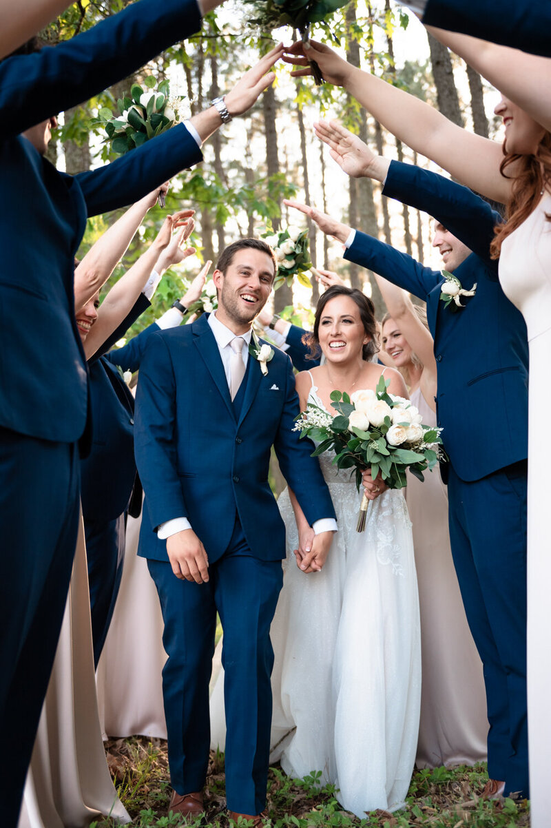 bride and groom hold each other's hands with their heads together under her veil in this richmond virginia wedding with emmiclaire photography