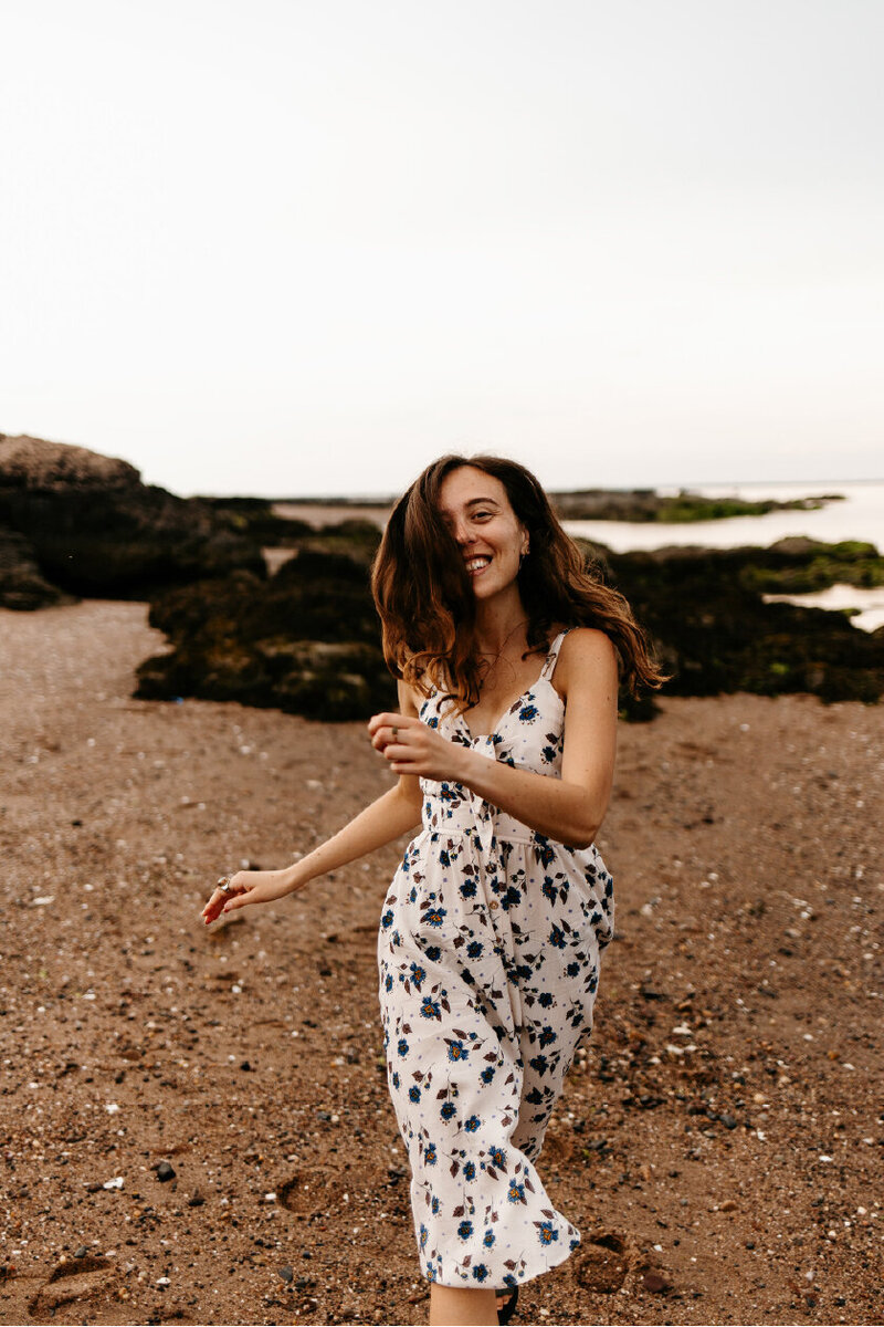 Rhianon  in dress walking on beach