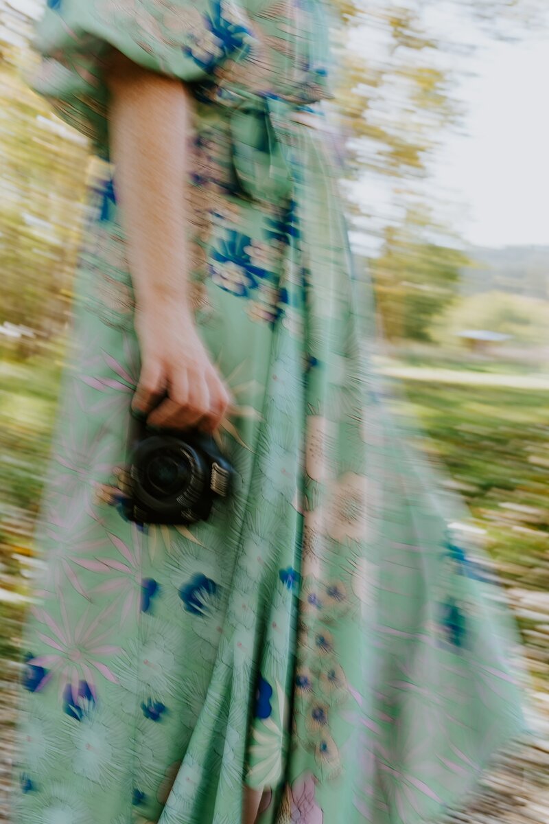 A stylistic blurred shot of Leanna holding a camera.