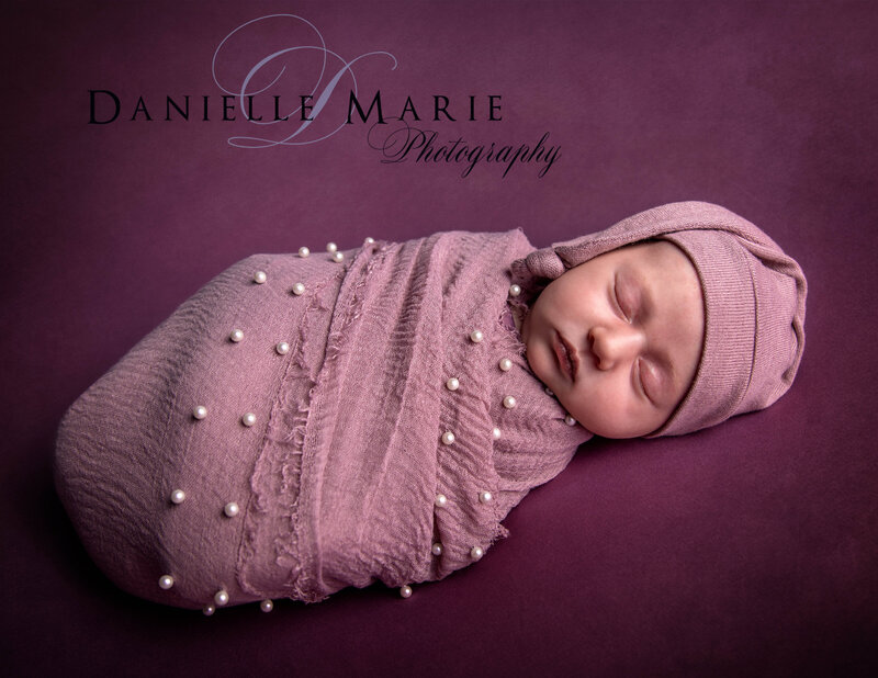 newborn baby wrapped in purple sleeping in New Jersey