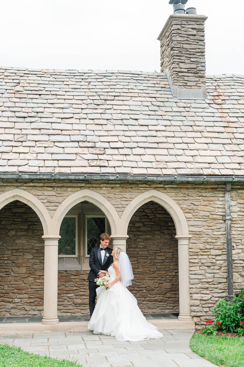 Bride and Groom stnad in front of Duncan Memorial Chapel on their wedding day
