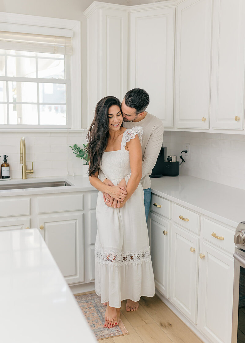 Couple hugging in kitchen
