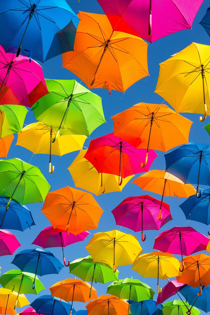 a flurry of rainbow colored umbrellas floating in the sky together overhead for socialfizz