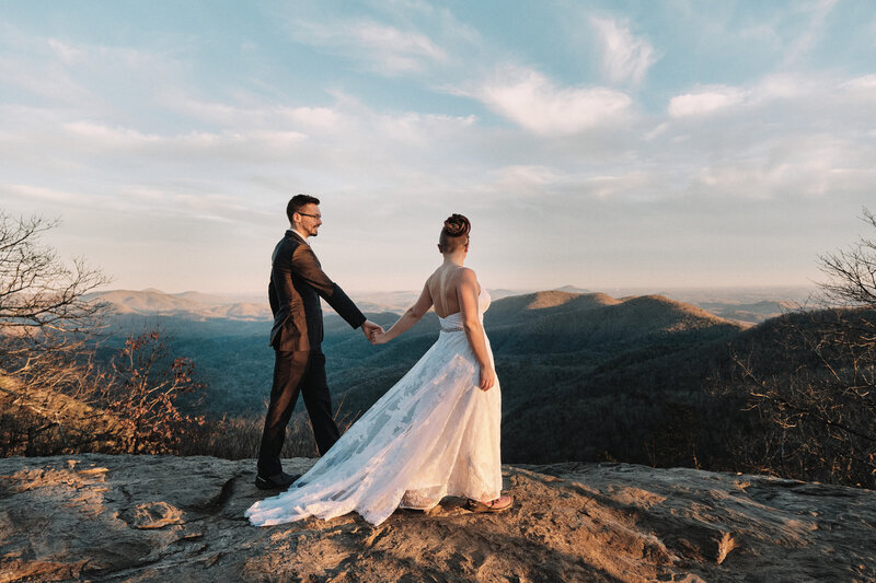 Eloping couple walking along a mountaintop in Georgia