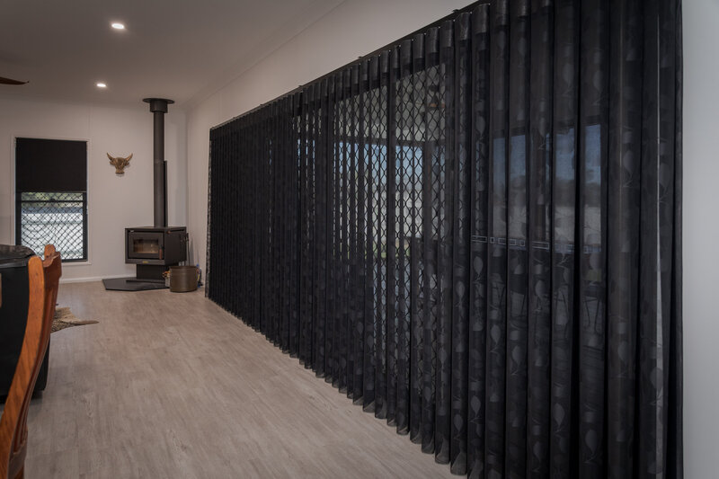 Stylish living room with custom black curtains, creating a polished and elegant look.