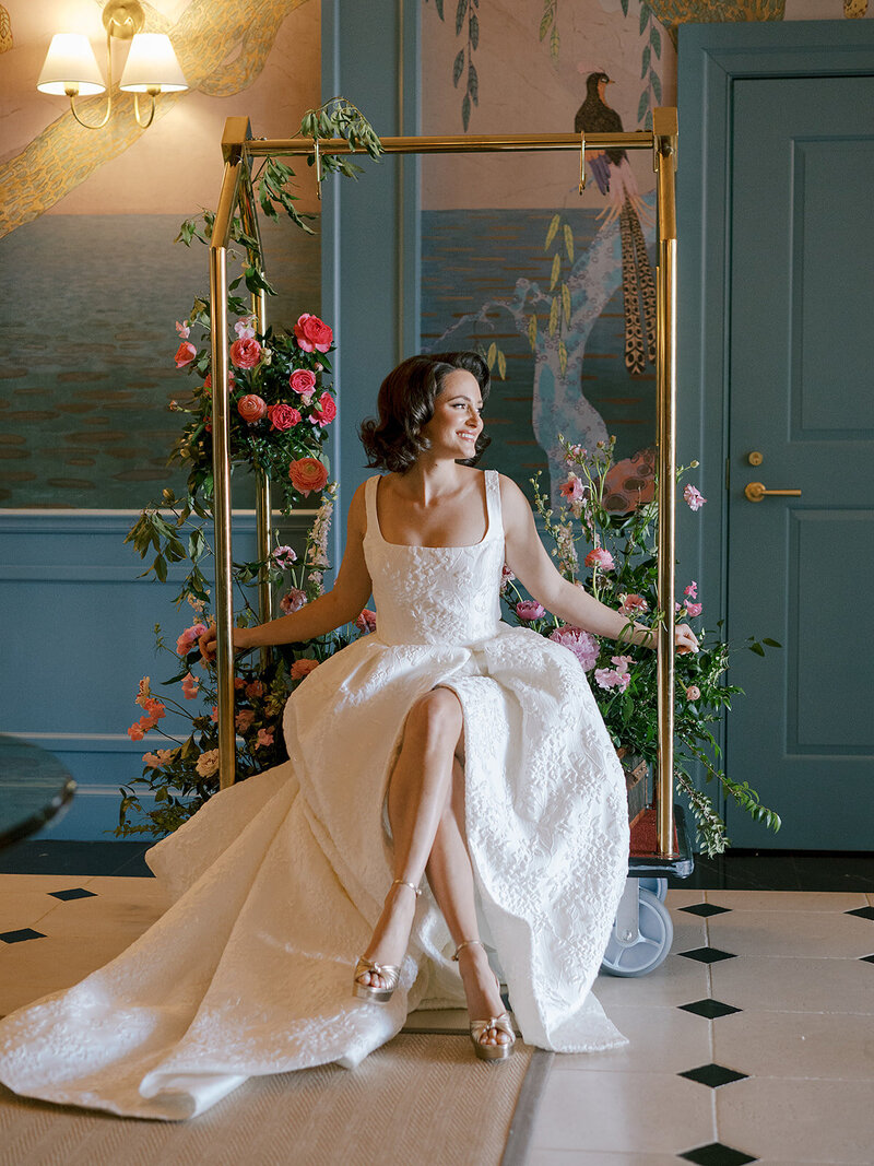 Bridal model posing with classic art installation