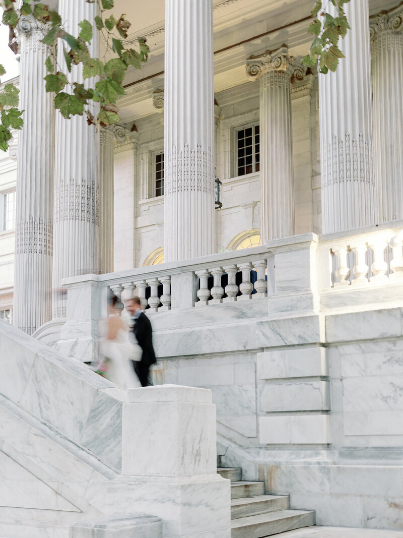 Bride and groom walk up the stairs of the DAR Constitution Hall