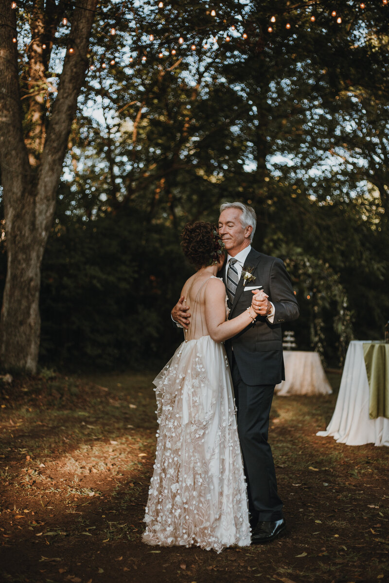 bride and her father dancing outside