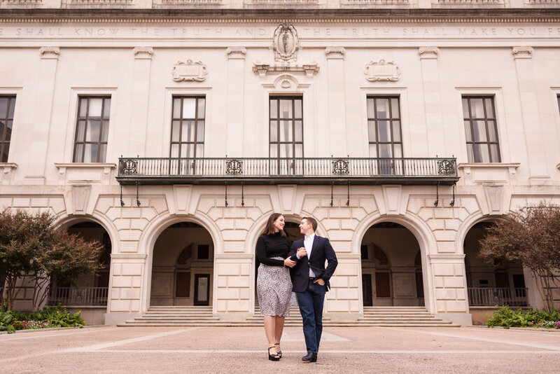 Couple walk together during their engagement session in the University of Texas in Austin. Photo taken by Austin Engagement Photographers, Joanna & Brett Photography