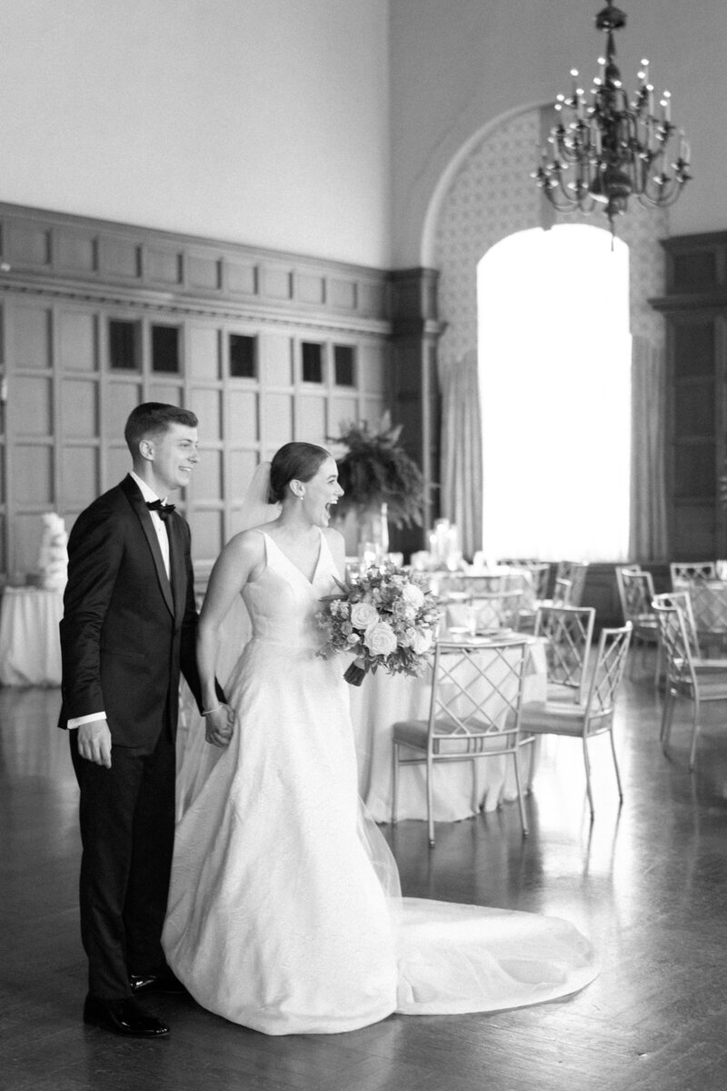 Bride and groom seeing reception set up and smiling taken by chicago film wedding photographer Allison Francois