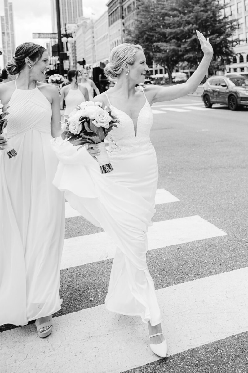 couple walking down Lasalle street in Chicago on their wedding day