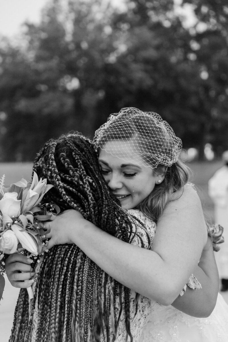 bride cries hugging her bridesmaid