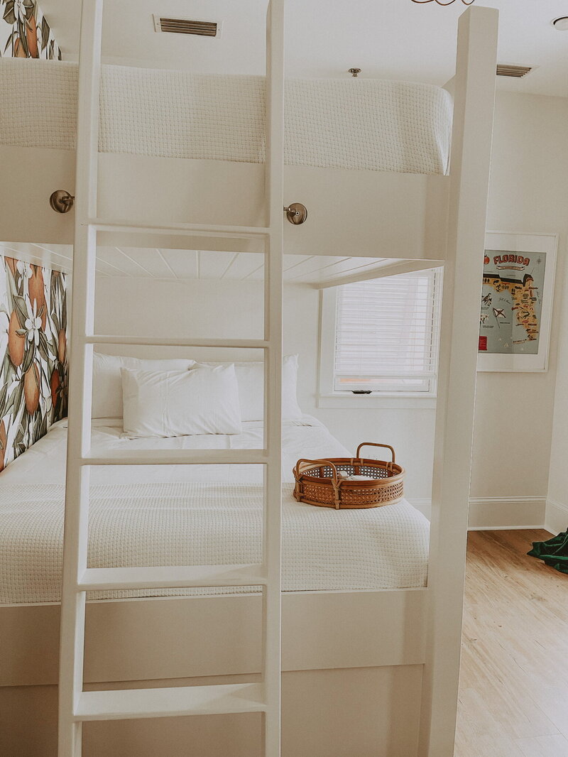 white bunk beds against wallpaper with orange groves