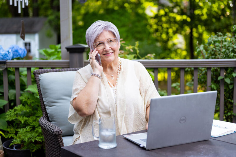 April chats on the phone with a client