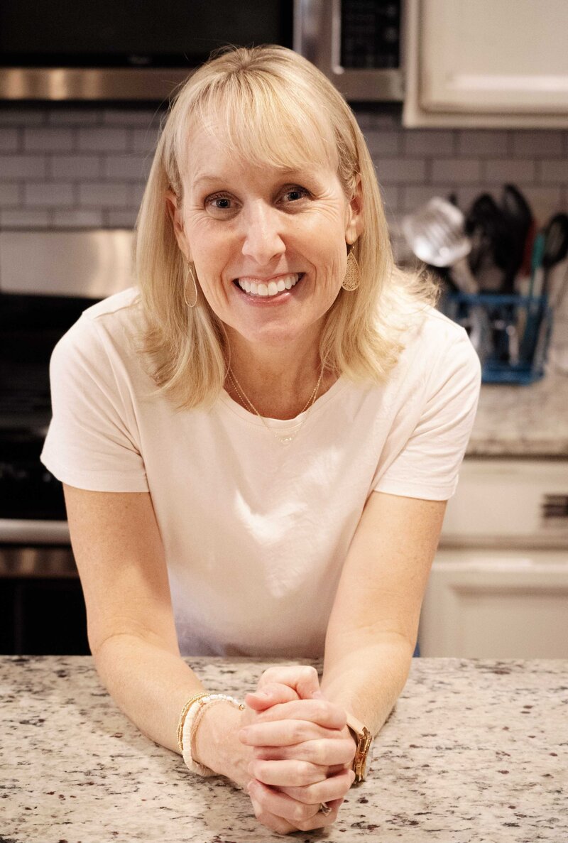 Zoe Schroeder, registered dietitian and fitness coach, smiling in workout gear, ready to guide clients through personalized fitness and nutrition programs.