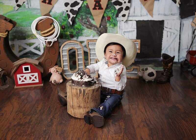 Cutie posing for the camera at his first birthday cake smash