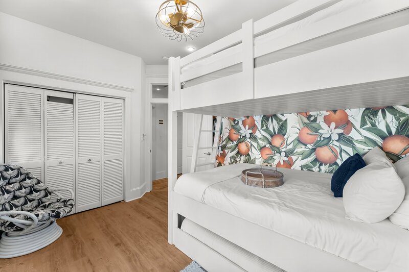Fun bunk room featuring queen bunks, colorful citrus wallpaper, and playful design at The Florida House near Santa Rosa Beach and Carillon Beach rentals.