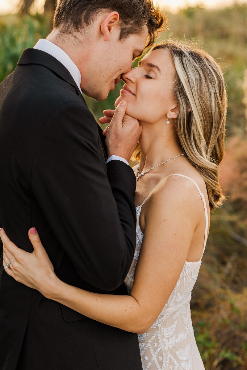 Bride and groom sharing a kiss on a tropical beach location.  Photograph taken by Meredith Mutza Photography LLC located in Milwaukee, Wisconsin.