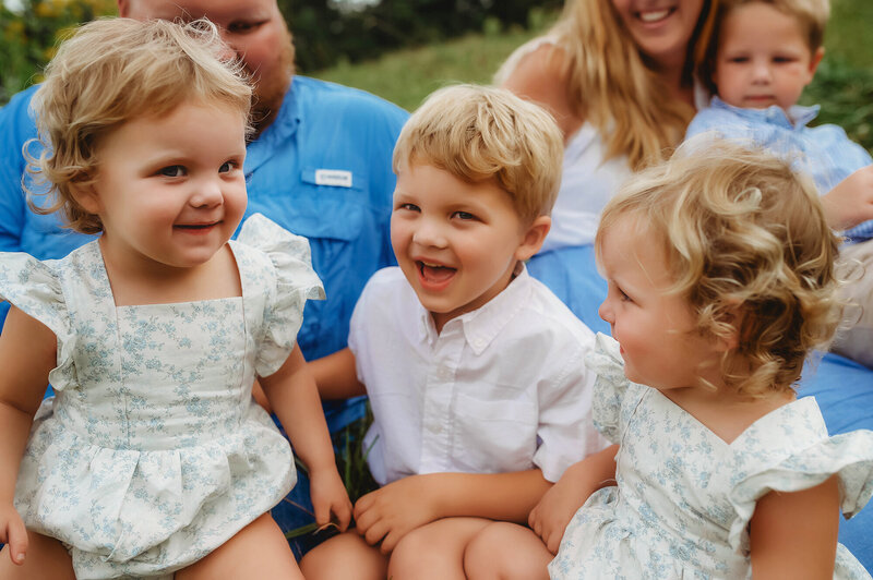 Small children laugh and play during Family Pictures in Asheville, NC.