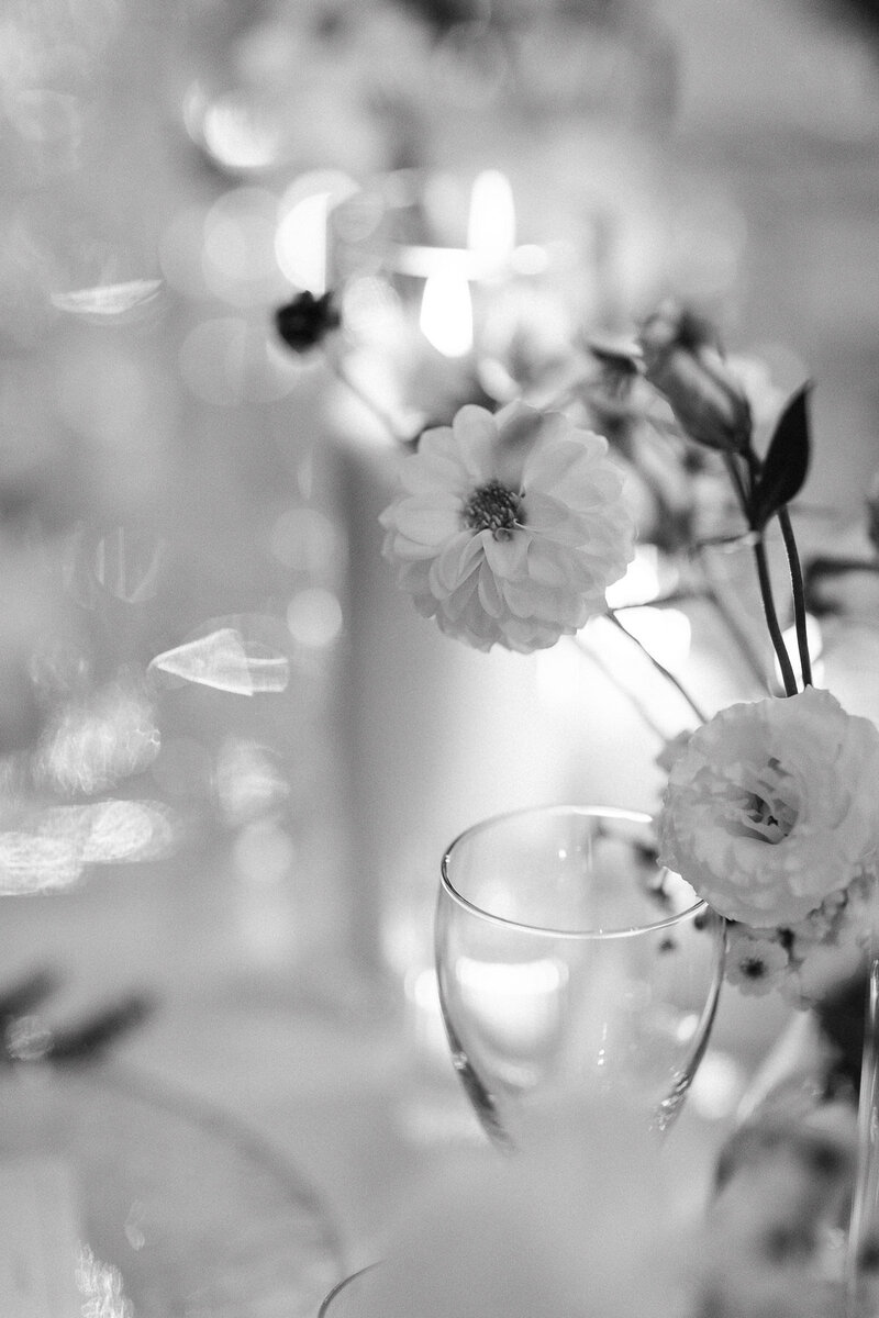 White flowers that serves to decorate a wedding reception table at night. 