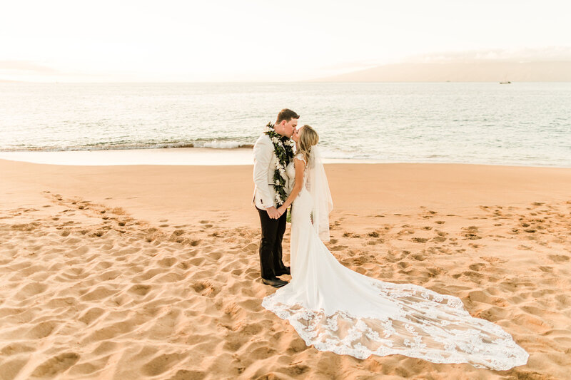 bride and groom kiss during Maui elopement on the beach