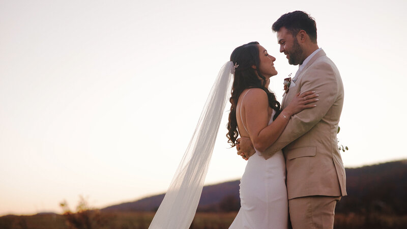 Wedding still image from a wedding video of a bride and groom looking into each other's eyes at a Virginia farmhouse wedding