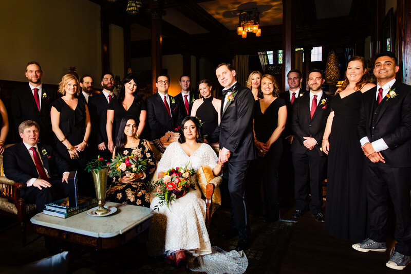A formal photo of a large wedding party in the historic Ford Mansion in Toledo Ohio