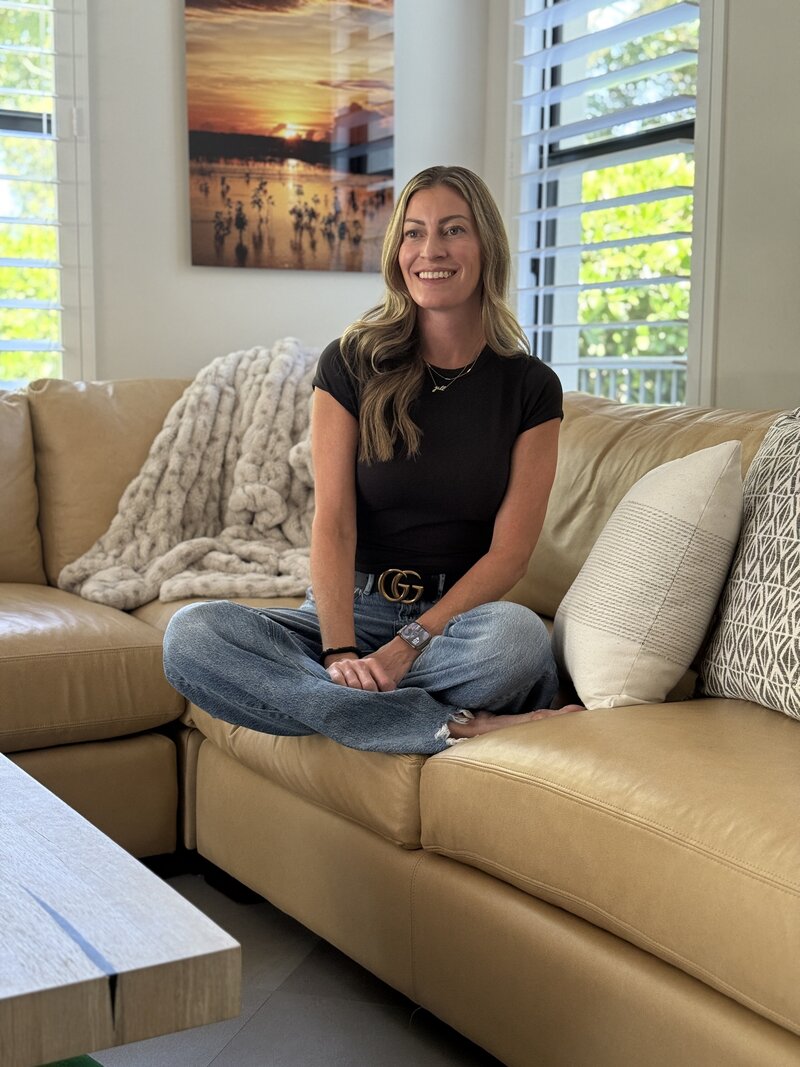 Jill smiling while sitting on couch