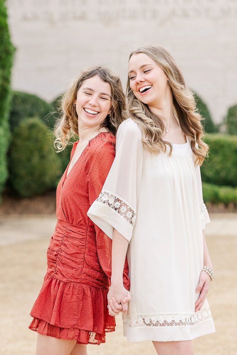 Sisters holding hands and laughing | Auburn Alabama Photographer Amanda Horne