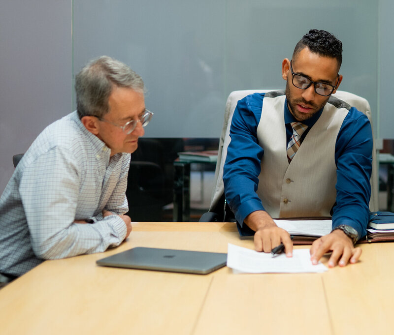 Divorce attorney sitting at a desk and advising first responder client in Central Ohio