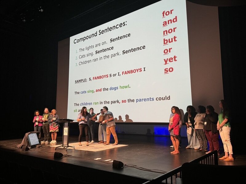 literacy consultant speaking on stage at a national conference