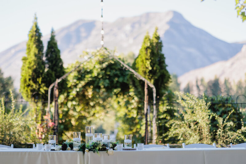 Wedding dinner table is set against the backdrop of the rocky mountains
