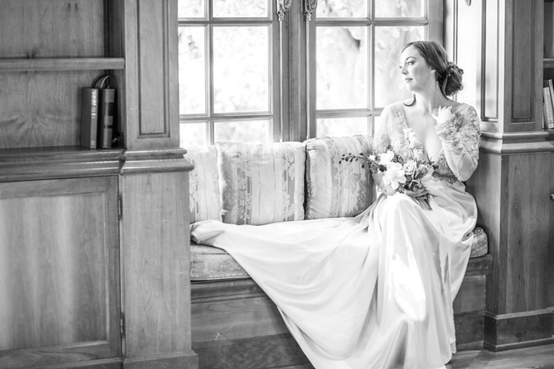 Bride sitting on sofa looking out window