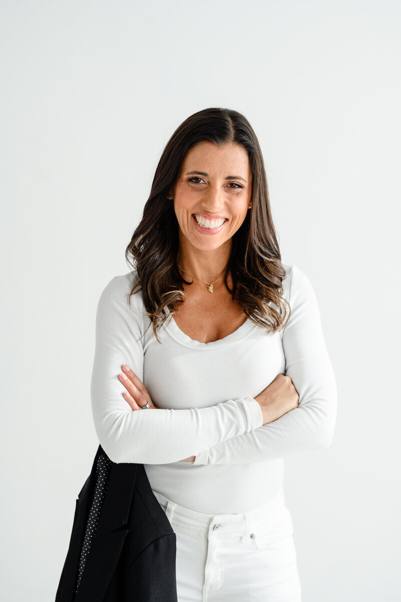 Jo, founder of Branding by Jo, stands confidently in  Orlando studio, highlighting her professional presence.