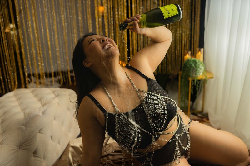 woman in black lingerie holding her heels
