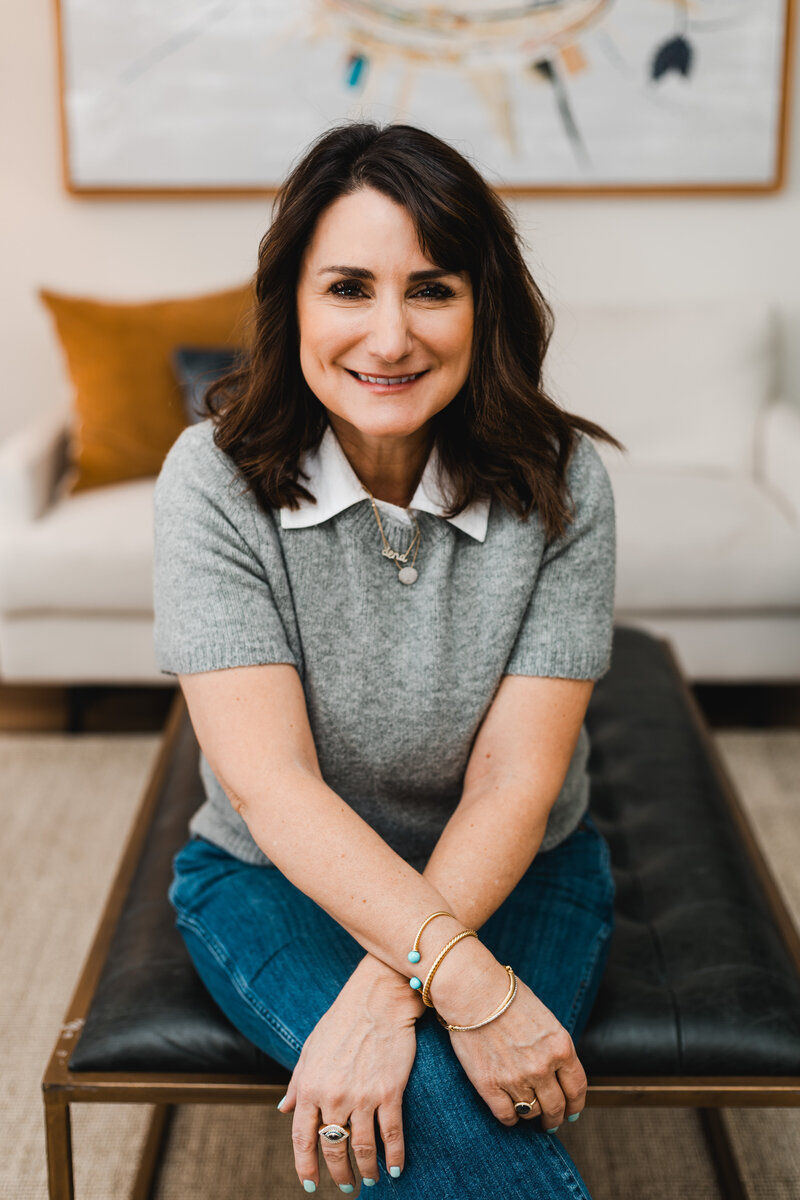 Dena smiling while sitting in her office