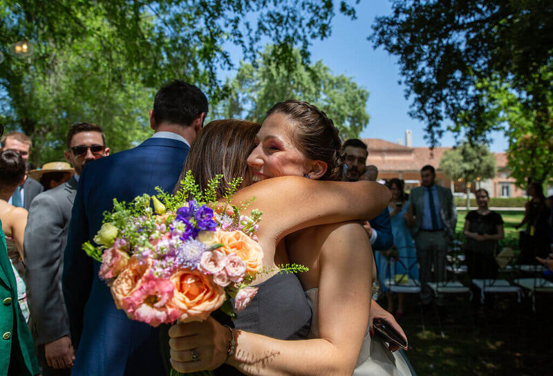 Bride hugging guest in sunhsine at Le Casa De Monico