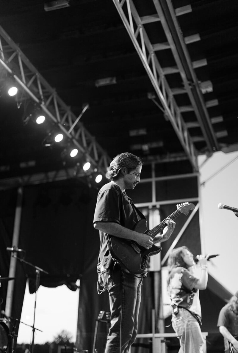 Music strategy consultant Dante Berardi on stage playing guitar