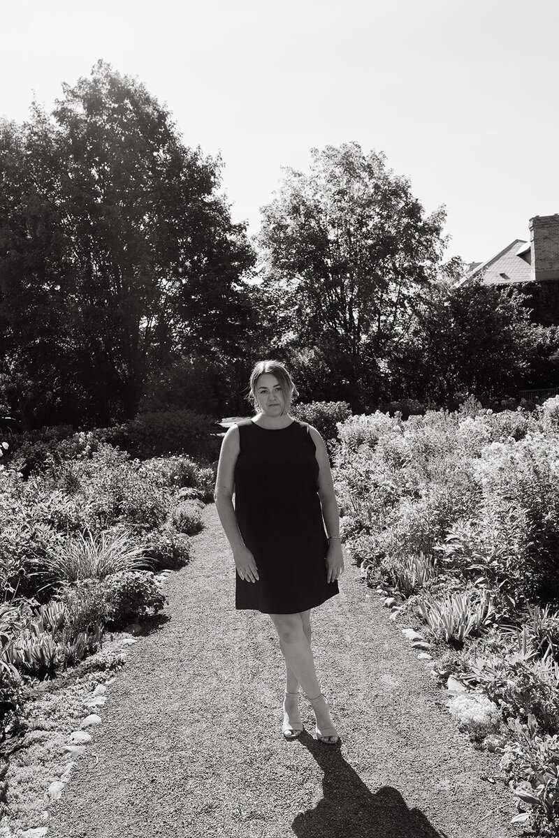 Danielle Aisling walking through a sunlit garden — Ottawa-based destination wedding photographer capturing cinematic, soulful imagery.