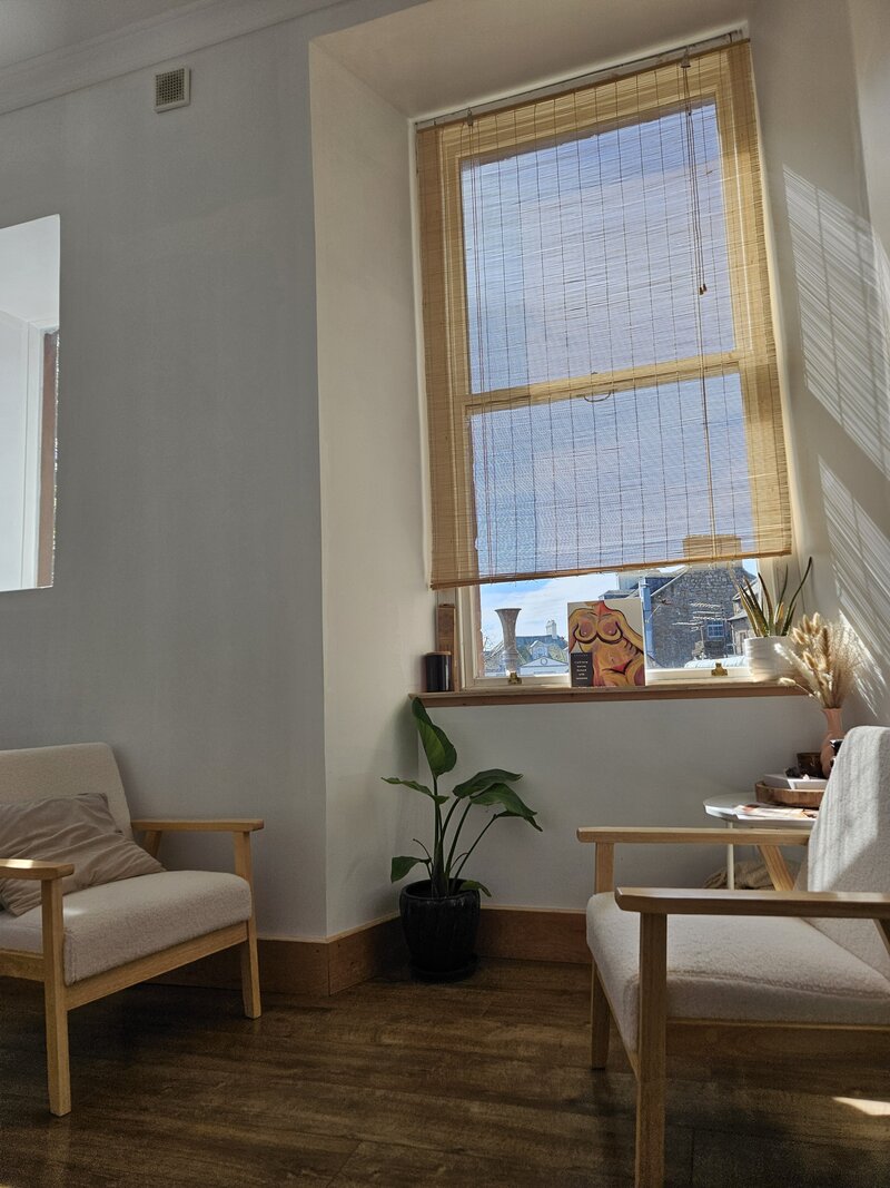 A painting of a naked female silhouette of her body, with a positive intention card next to it.