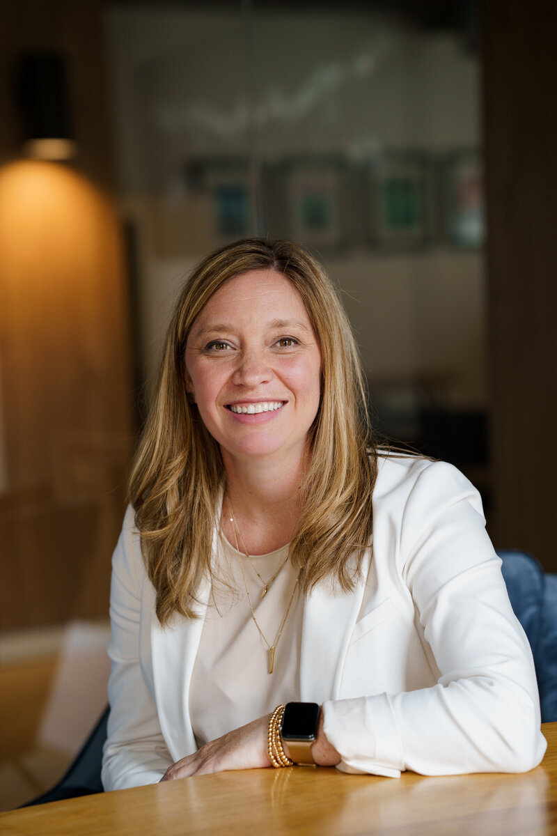 People sitting at a conference table, smiling
