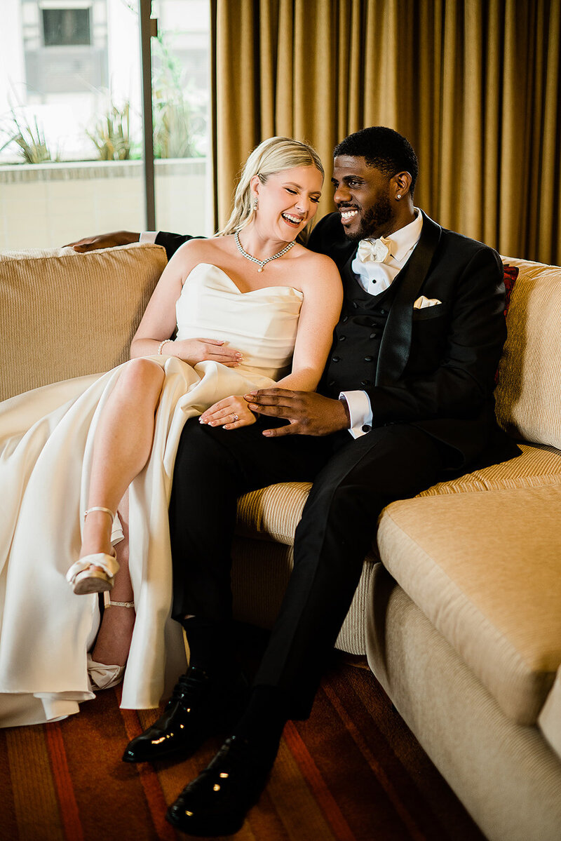 inerracial  wedding couple poses on rooftop near seattle waterfront