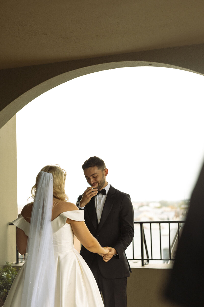 Two people sharing an intimate moment under an umbrella at dusk.
